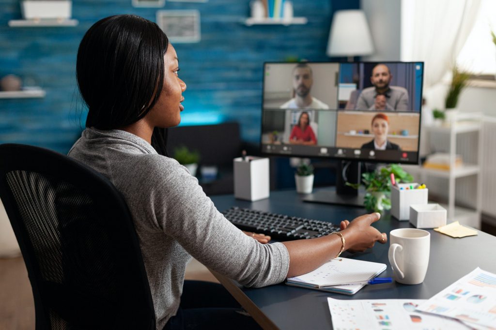 Black student discussing with university team during online videocall meeting conference